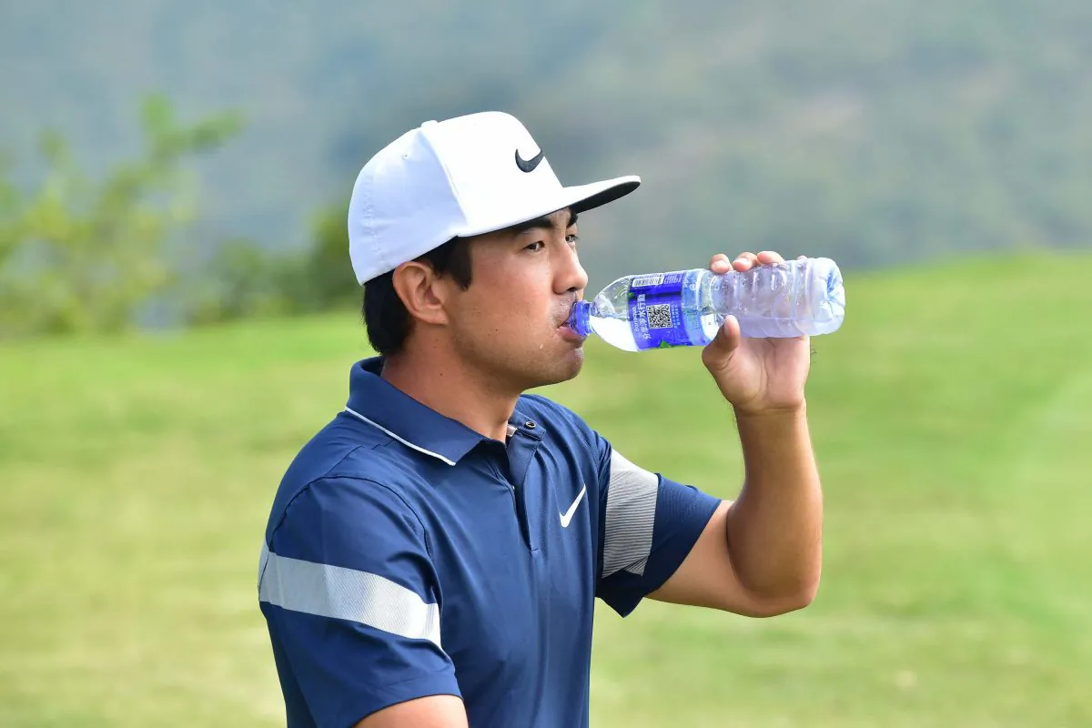 Alexander Kang takes a drink as he moves off the 10 Tee in round 3 of the PGA Tour China Series Clearwater Bay Open on Saturday Nov 5, 2016. Kang finished the day leading the field by 4 shots on 14 under par 196 total. (Bill Cox/Epoch Times)