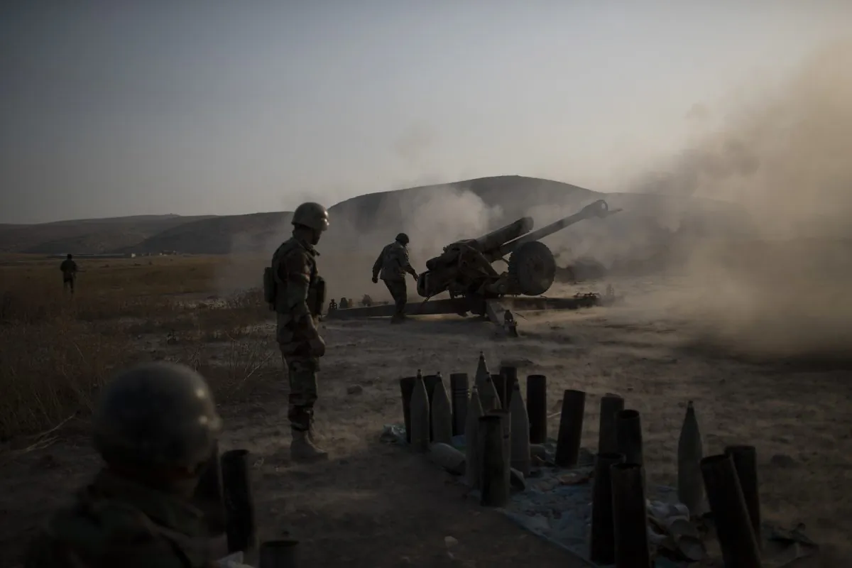 Kurdish Peshmerga soldiers fire artillery at Islamic State positions in Bashiqa, east of Mosul, Iraq, Monday, Nov. 7, 2016. Iraqi Kurdish fighters are exchanging heavy fighters with militants as they advance from two directions on a town held by the Islamic State group east of the city of Mosul. (AP Photo/Felipe Dana)