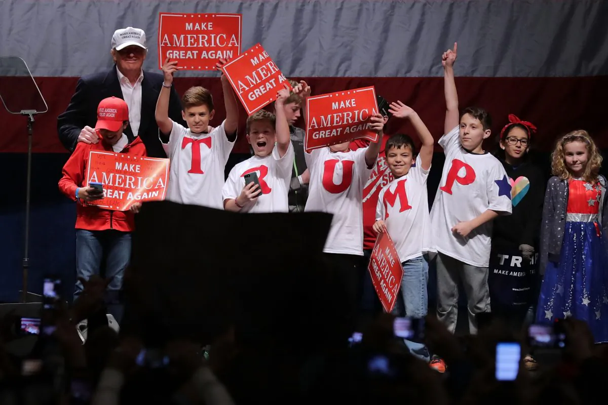 Republican presidential nominee Donald Trump invites a group of children on stage during a campaign rally at the Freedom Hill Amphitheater in Sterling Heights, Michigan on Nov. 6, 2016. With less than 48 hours until Election Day in the United States, Trump and his opponent, Democratic presidential nominee Hillary Clinton, are campaigning in key battleground states that each must win to take the White House. (Chip Somodevilla/Getty Images)