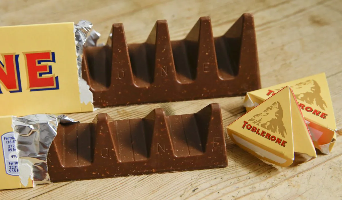 Two bars of the Toblerone Swiss chocolate are shown, at front is the new style 150 gram bar showing the reduction in triangular pieces, in the background is the older style 360 gram bar, in London on Nov. 8, 2016. (Alastair Grant/AP Photo)