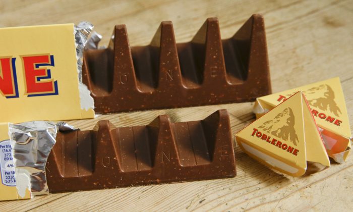 In this photo illustration two bars of the Toblerone Swiss chocolate are shown, at front is the new style 150 gram bar showing the reduction in triangular pieces, in the background is the older style 360 gram bar, pictured in London, on Nov. 8, 2016. (Alastair Grant/AP Photo)