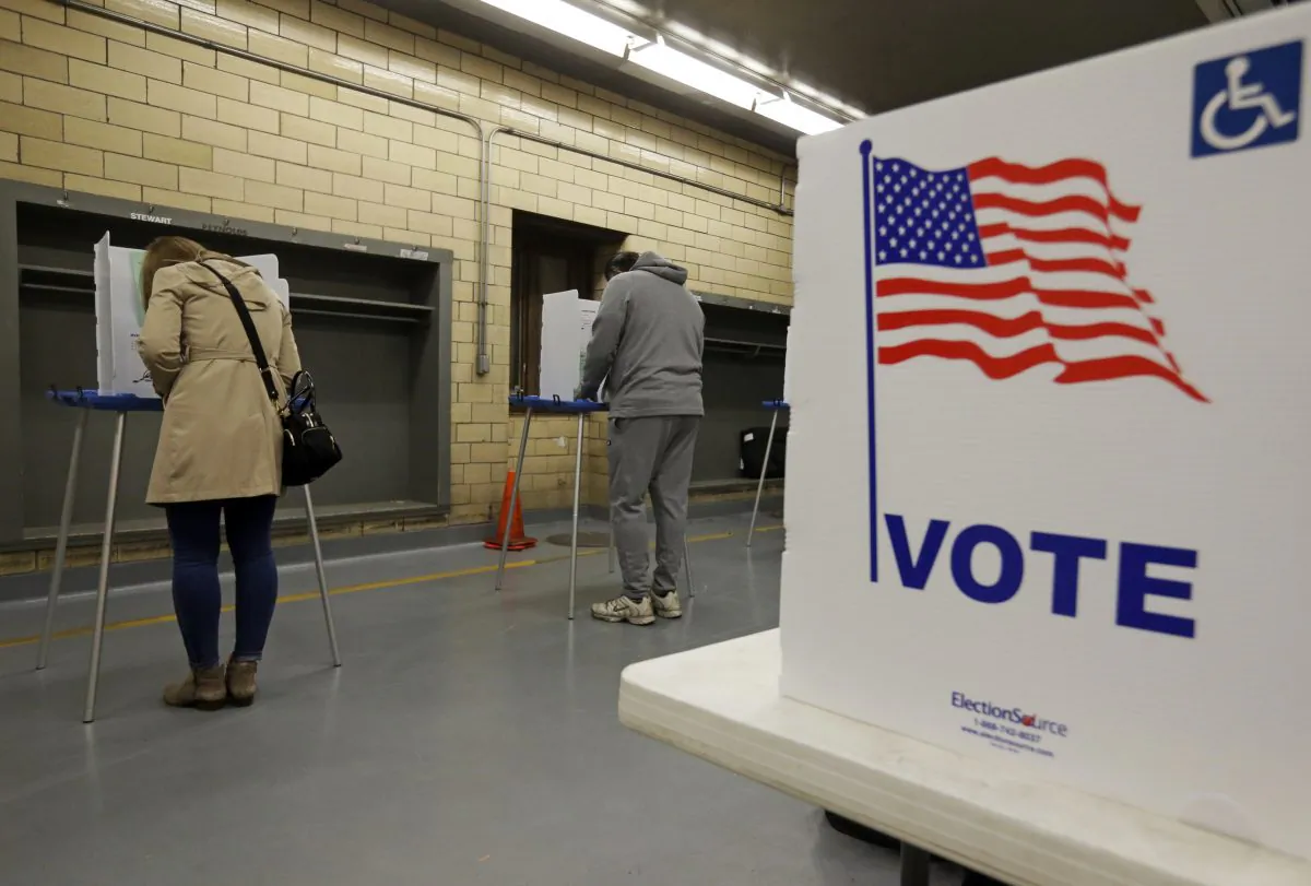 Voters cast their votes in a fire station in Indianapolis, Tuesday, Nov. 8, 2016. (AP Photo/Michael Conroy)