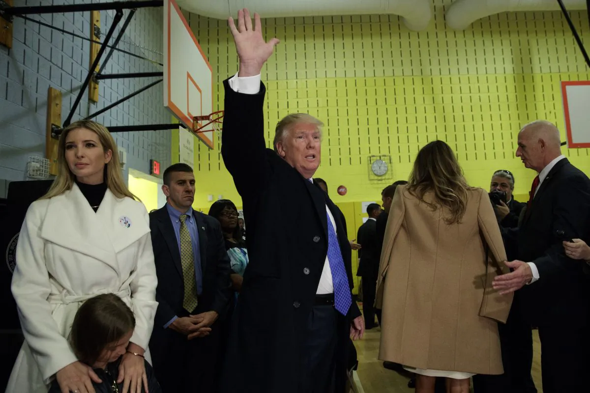Republican presidential candidate Donald Trump waves after casting his ballot at PS-59, in New York, on Nov. 8, 2016. (AP Photo/ Evan Vucci)