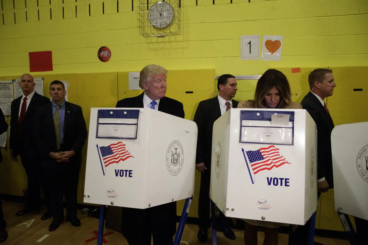 Republican presidential candidate Donald Trump looks at his wife Melania as they cast their votes at PS-59,  in New York, on Nov. 8, 2016. (AP Photo/ Evan Vucci)