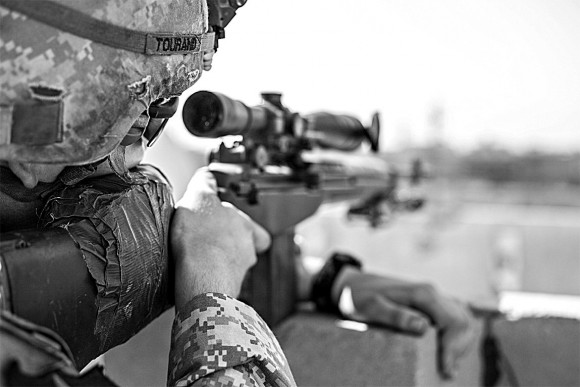 Sgt. Joe Tourand scans the Daura neighborhood of southern Baghdad during the troop surge of 2007. (Courtesy of Emmet Cullen)