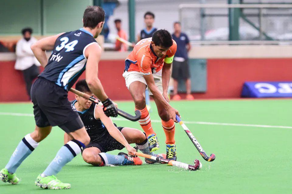HKFC-A players steal the ball from Khalsa-A’s Arshad Mohammad during their HKHA Premier Division game at HKFC on Sunday Nov 6, 2016. (Bill Cox/Epoch Times)