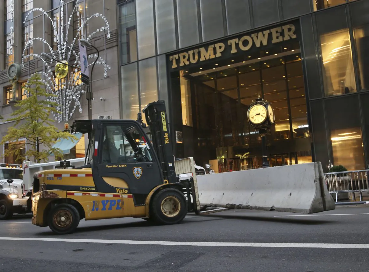 Police officers help to install concrete barriers around Trump Tower, the home of President-elect Donald Trump, in New York on Nov. 9, 2016. Trump, against all odds, won election as America's 45th president. (AP Photo/Seth Wenig)