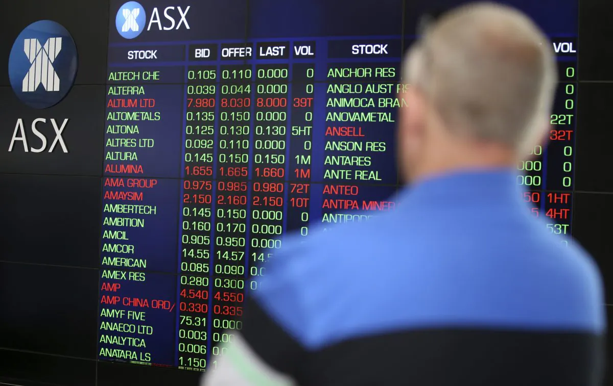 A man watches the display board at the Australian Stock Exchange in Sydney, Australia on Nov. 10, 2016. (Rick Rycroft/AP)