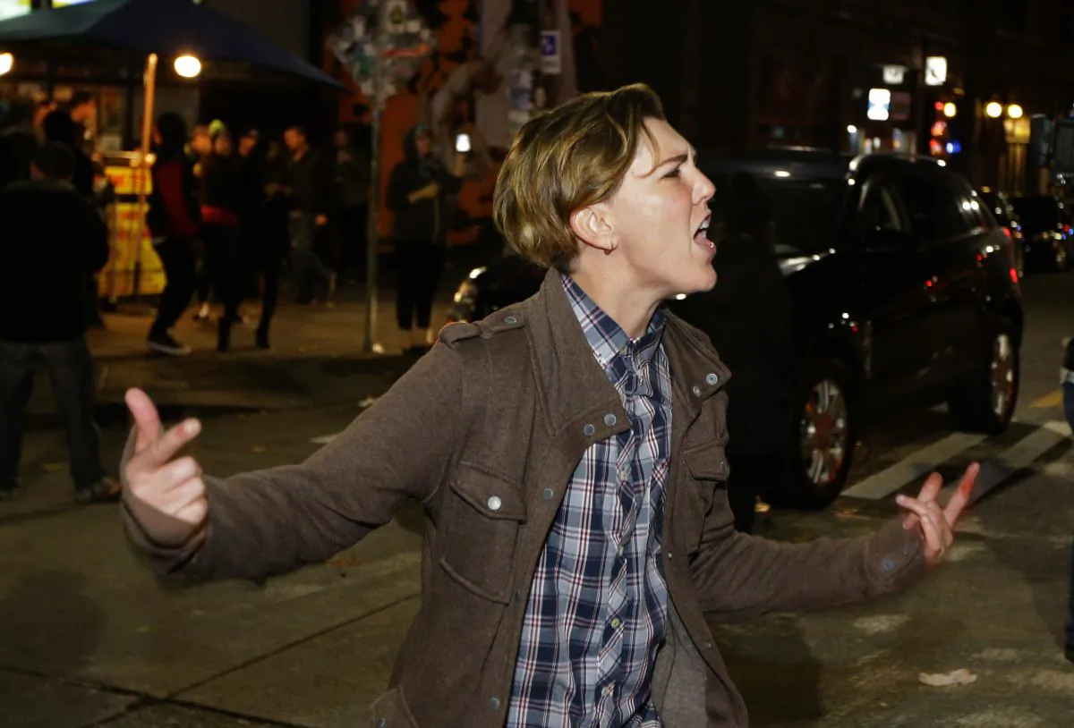 A person yells during a protest against President-elect Donald Trump, Wednesday, Nov. 9, 2016, in Seattle's Capitol Hill neighborhood. (AP Photo/Ted S. Warren)