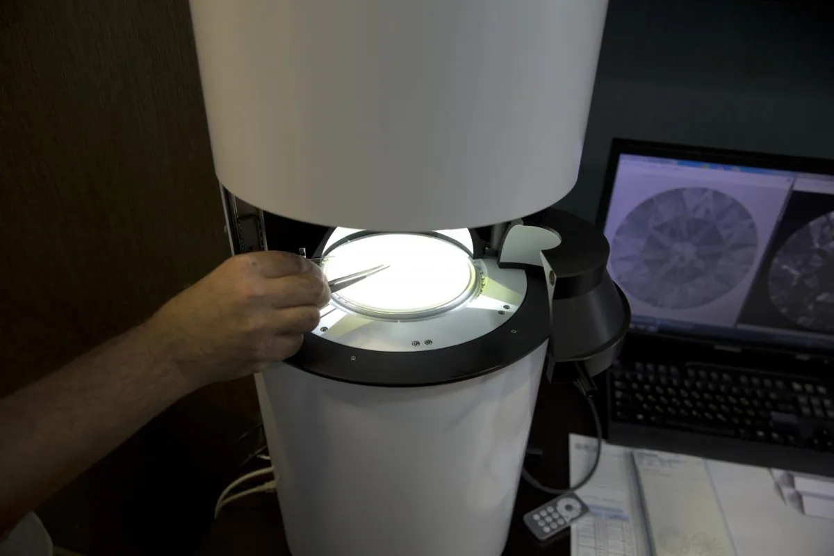 Sarine Technologies Ltd. employ puts a diamond in a machine that can instantly grade the clarity of polished diamonds in Ramat Gan, Israel on Nov. 10, 2016. The Israeli high-tech company says the development will bring new standards to a painstaking process that has long been subject to the whims of human subjectivity. (AP Photo/Ariel Schalit)