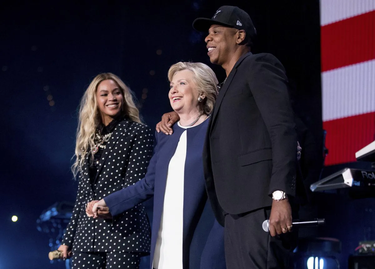 FILE - In this Nov. 4, 2016 file photo, Democratic presidential candidate Hillary Clinton, center, appears on stage with artists Jay Z, right, and Beyonce during a free concert at at the Wolstein Center in Cleveland. Few presidential candidates attracted so much celebrity support as did the former first lady and Secretary of State, but to so little reward. Rallies in Ohio with Beyonce and Jay Z did not prevent Republican rival and President-elect Donald Trump from prevailing. (AP Photo/Andrew Harnik, File)