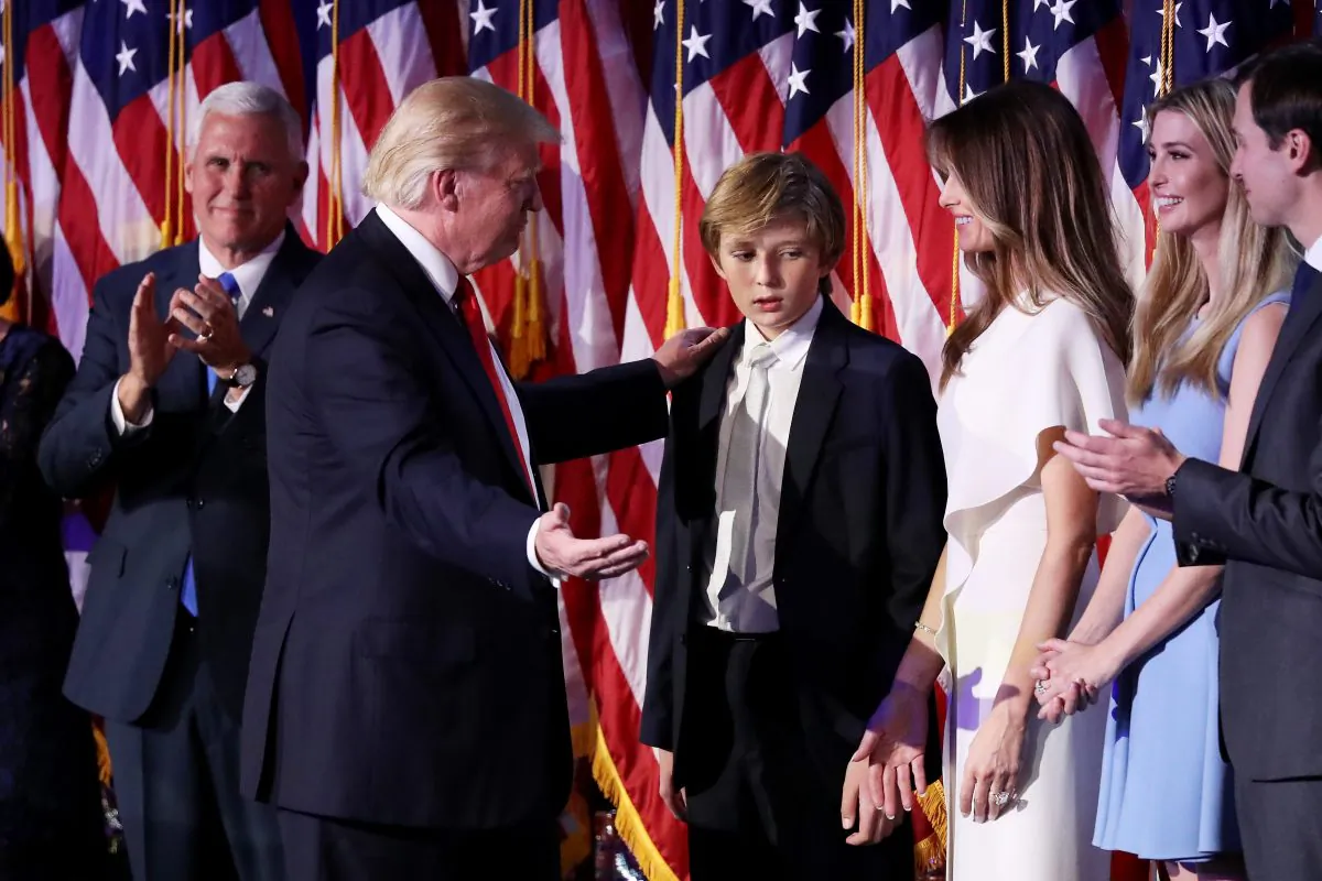 Republican president-elect Donald Trump acknowledge his son Barron Trump (C) after delivering his acceptance speech at the New York Hilton Midtown in  in New York City, on Nov. 9, 2016.  (Photo by Joe Raedle/Getty Images)