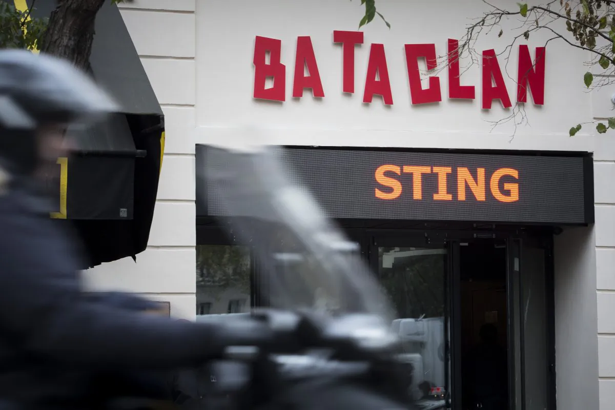 A man rides his scooter in front of the Bataclan concert hall in Paris, France, Saturday, Nov. 12, 2016. (AP Photo/Kamil Zihnioglu)