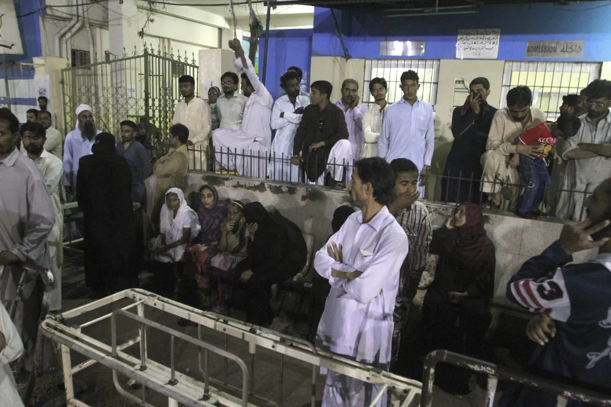 People gather outside an emergency ward of a local hospital after hearing news of a bomb blast at a Sufi shrine, in Karachi, Pakistan, on Nov. 12, 2016. (AP Photo/Fareed Khan)