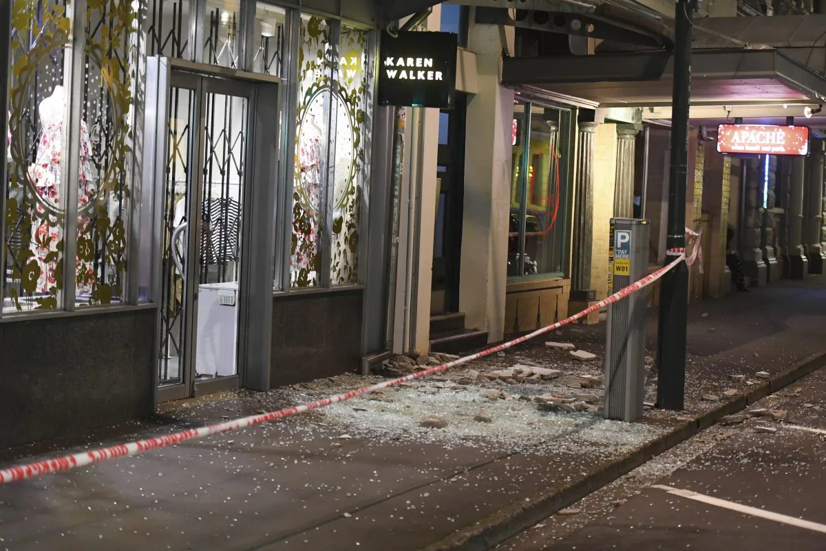 Glass and masonry litter the footpath in Wellington on Nov. 14, 2016. (Ross Setford/SNPA via AP)