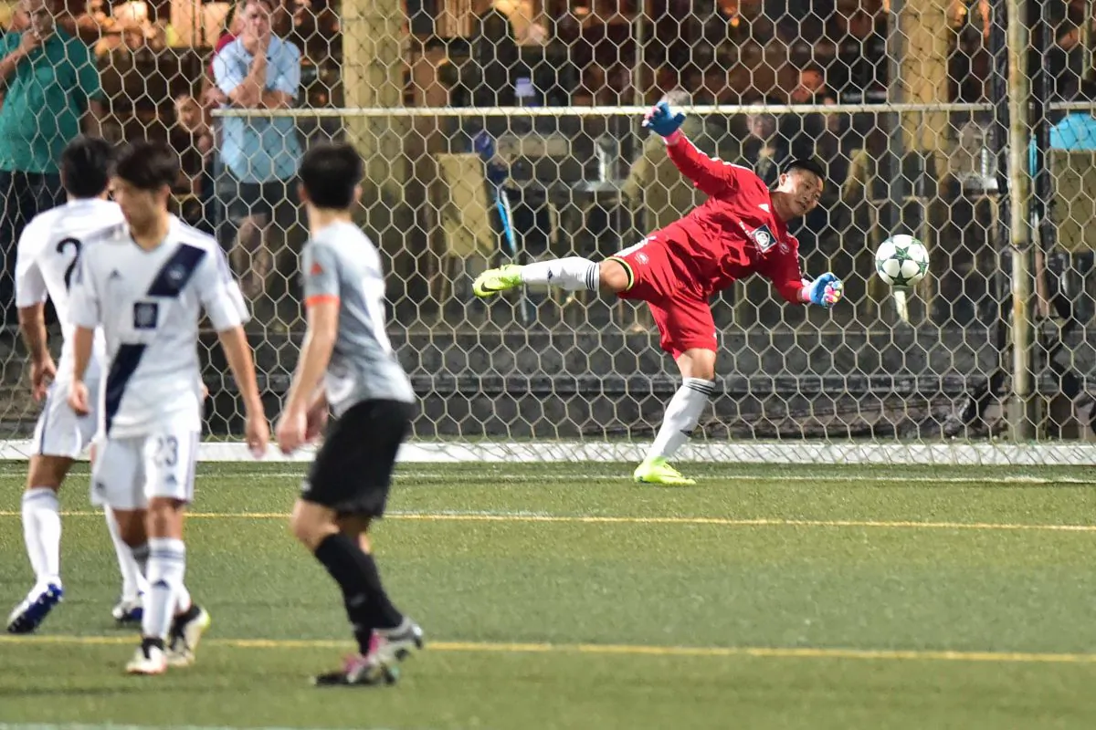 Free kick save by Lucky Mile goalie keeps the score at 2-1 in their HKFA division 2 match against HKU CXSC Sun Source at Sports Road on Sunday Nov 13, 2016. (Bill Cox/Epoch Times)