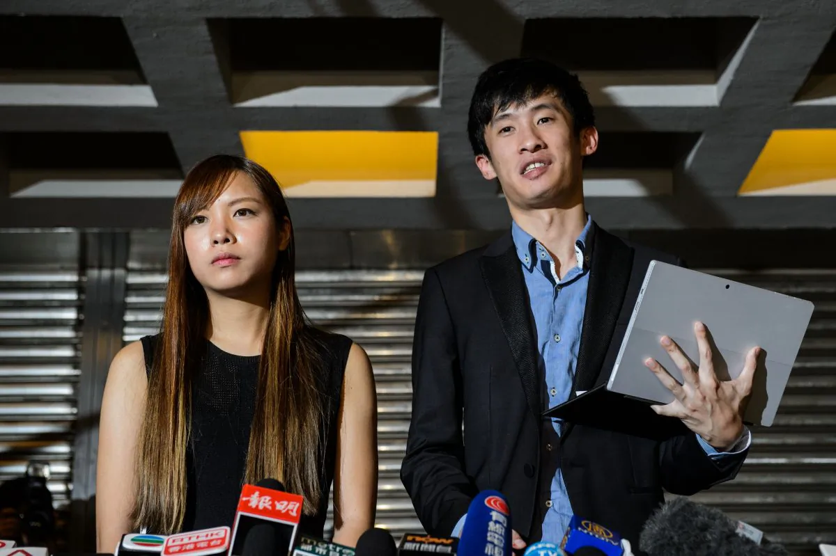 (R-L) Pro-independence lawmakers Baggio Leung and Yau Wai-ching speak to the press outside the High Court in Hong Kong on November 15, 2016. (Anthony Wallace/AFP/Getty Images)