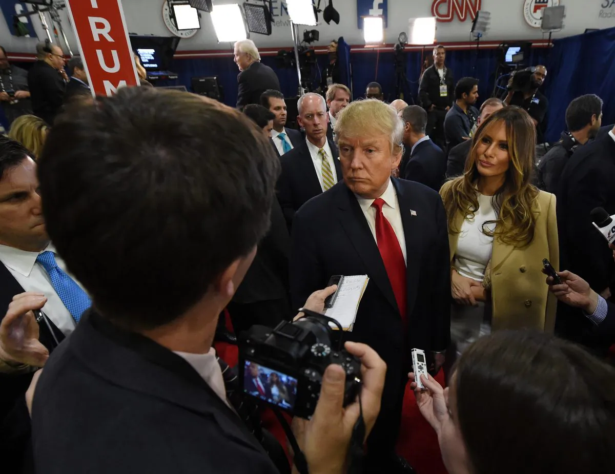 Republican presidential candidate Donald Trump (C) and his wife Melania Trump talk to reporters in the spin at The Venetian Las Vegas on Dec. 15, 2015. (Ethan Miller/Getty Images)