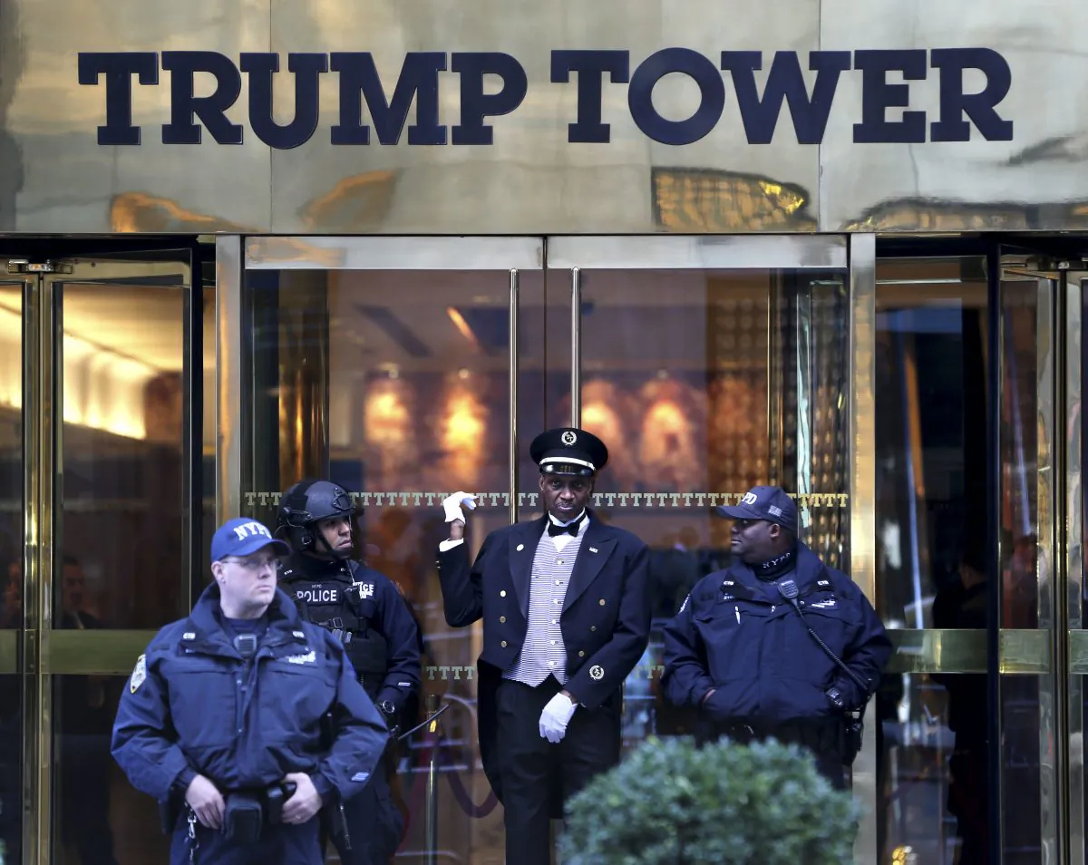 A doorman (C) talks with security personnel at the front entrance of Trump Tower in New York, on Nov. 17, 2016. (AP Photo/Seth Wenig)
