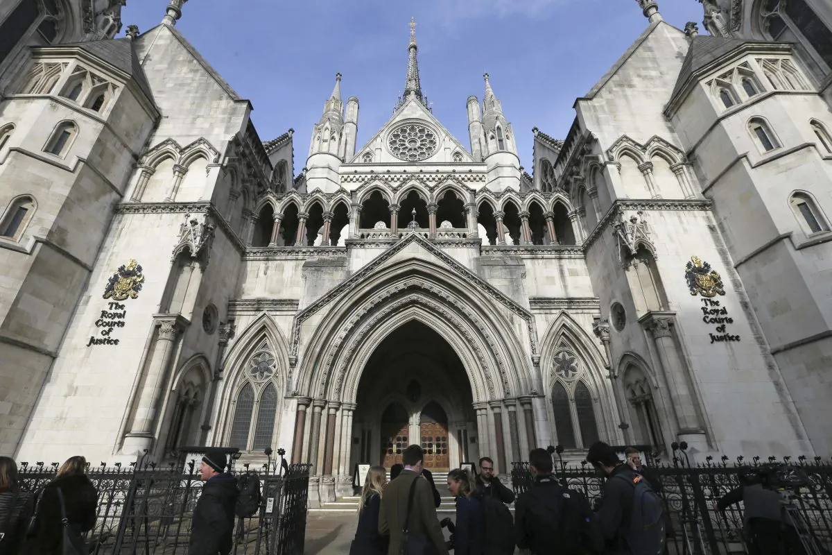 Media gather outside the High Court in London, in this file photo. (Tim Ireland, File/AP Photo)