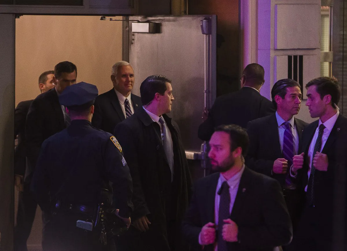 Vice President-elect Mike Pence, top center, leaves the Richard Rodgers Theatre after a performance of "Hamilton," in New York, Friday, Nov. 18, 2016. (AP Photo/Andres Kudacki)