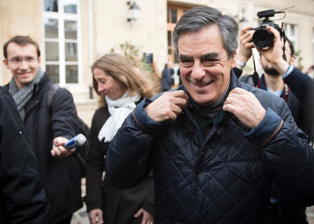 Candidate for the conservative Les Republicains (LR) party primaries ahead of the 2017 presidential election and former French prime minister Francois Fillon (R) leaves after voting at a polling station, in Paris on Nov. 20, 2016 (MARTIN BUREAU/AFP/Getty Images)