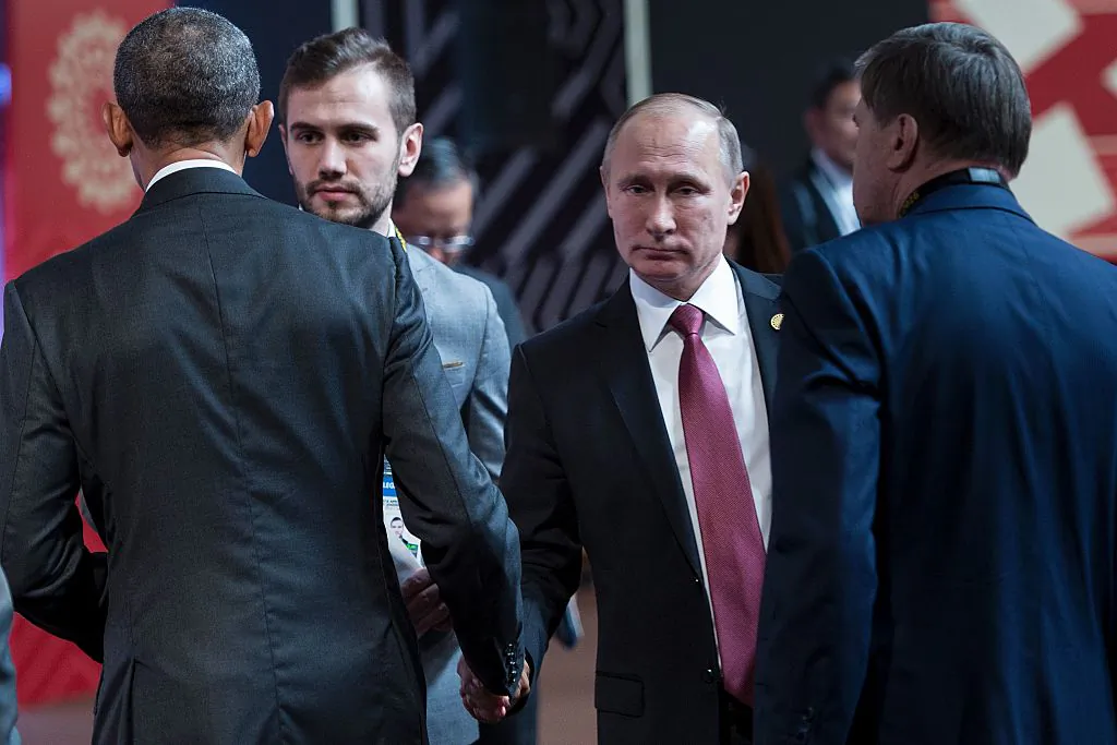 US President Barack Obama (L) and Russia's President Vladimir Putin (2nd-R) shake hands before an economic leaders meeting at the Asia-Pacific Economic Cooperation Summit at the Lima Convention Centre in Lima on Nov. 20, 2016. (BRENDAN SMIALOWSKI/AFP/Getty Images)