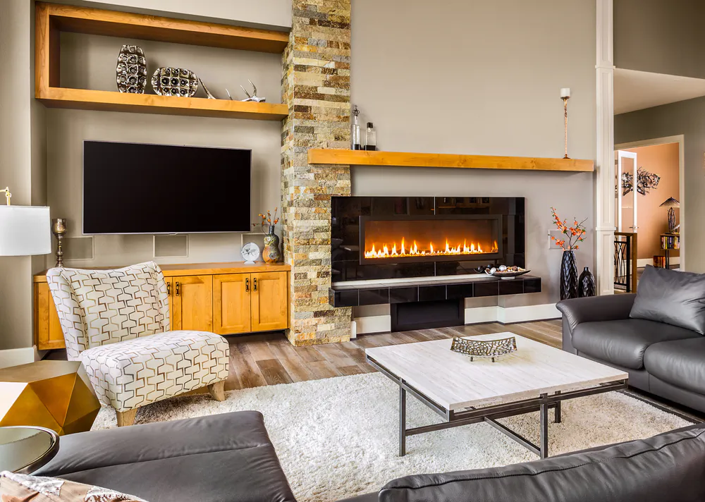 Adding an electric fireplace to the living room creates a warm and inviting atmosphere. (Breadmaker/Shutterstock)