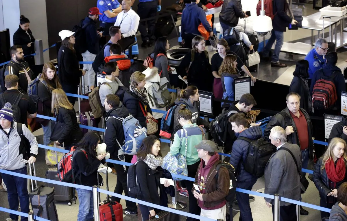Travelers line up at a security checkpoint area in Terminal 3 at O'Hare International Airport in Chicago in this Nov. 29, 2015 file photo. Hundreds of O'Hare International Airport workers that are trying to unionize have voted to go on strike ahead of the 2016 Thanksgiving holiday. Officials with the Service Employees International Union Local 1 said on Nov. 17, 2016, that about 500 workers have committed to strike. (AP Photo/Nam Y. Huh, File)