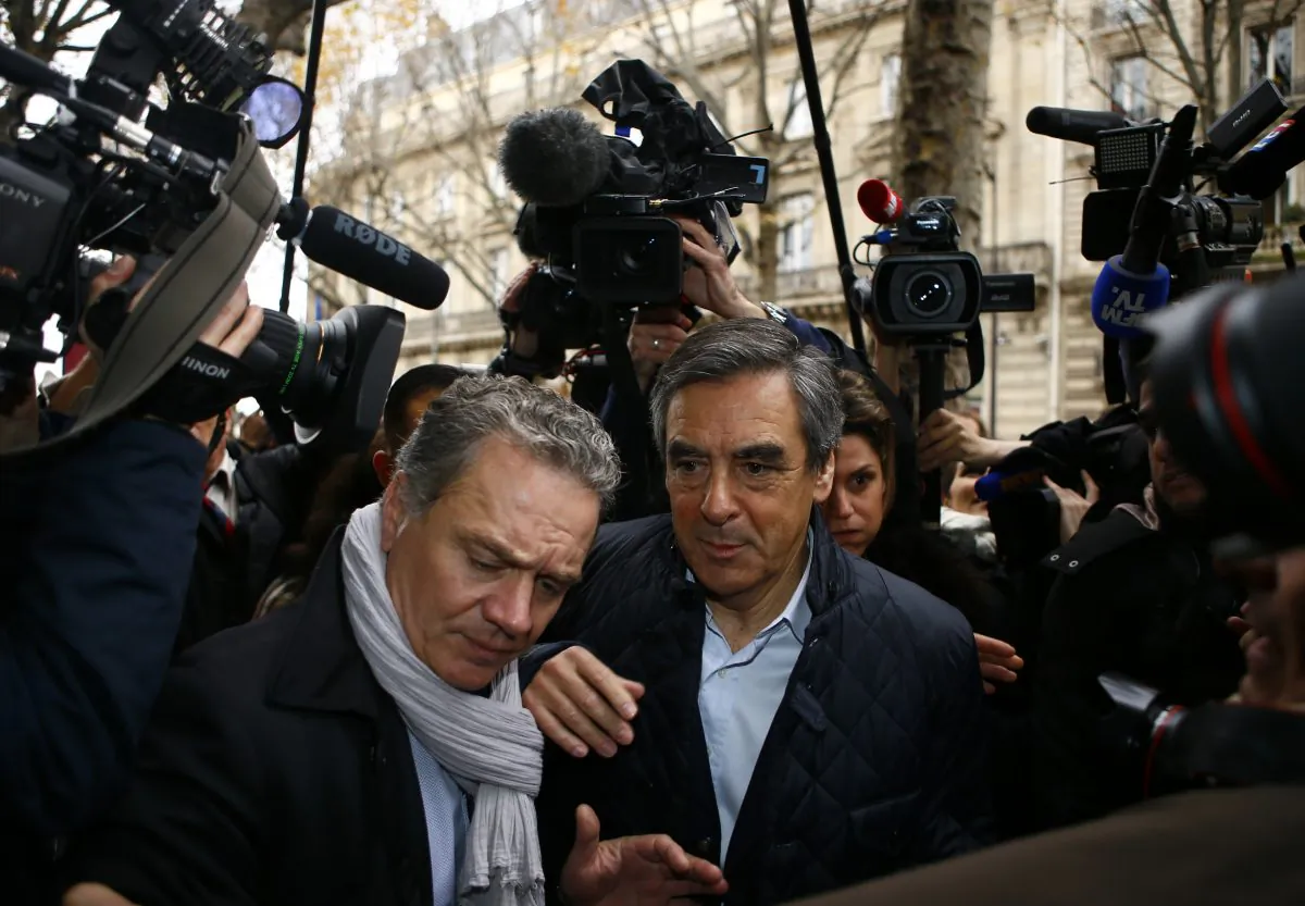 Francois Fillon, right, arrives with his bodyguard at his campaign headquarters in Paris on Nov.21, 2016. Former Prime Ministers Fillon and Alain Juppe will meet in a runoff next Sunday for the nomination to be France's conservative candidate for president. (AP Photo/Francois Mori)
