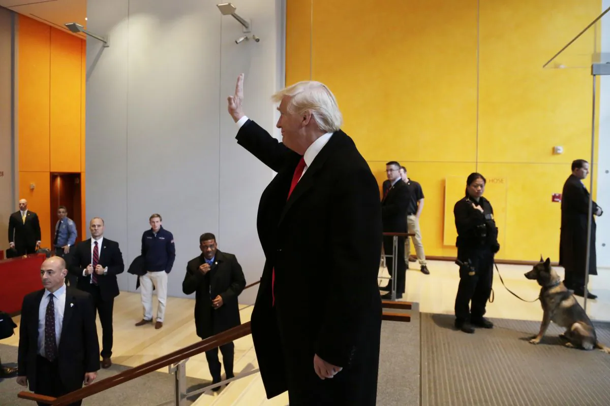 President-elect Donald Trump waves to a crowd in the lobby of the New York Times building following a meeting in New York on Nov. 22, 2016. (AP Photo/Mark Lennihan)