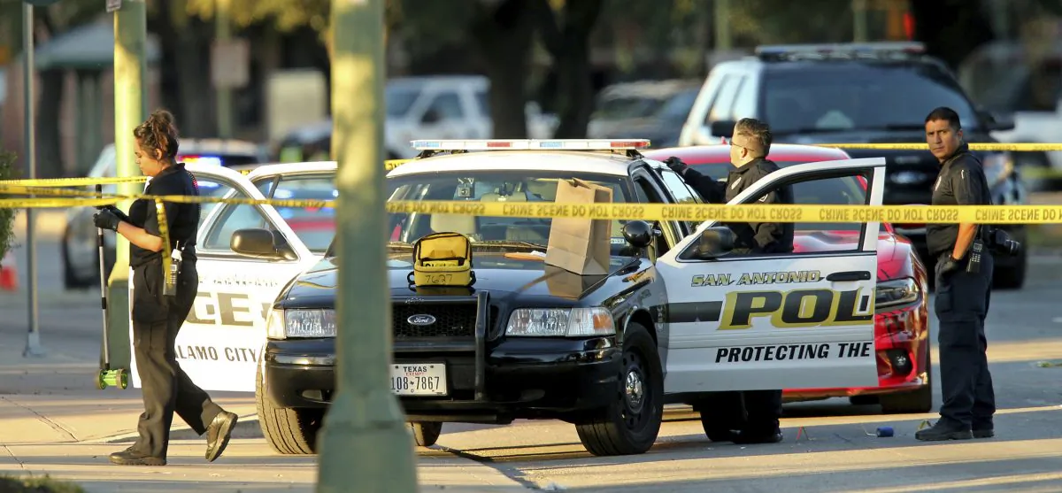 San Antonio Police Department personnel investigate the scene after Det. Benjamin Marconi was fatally shot in San Antonio on Nov. 20, 2016. (Edward A. Ornelas/The San Antonio Express-News via AP)