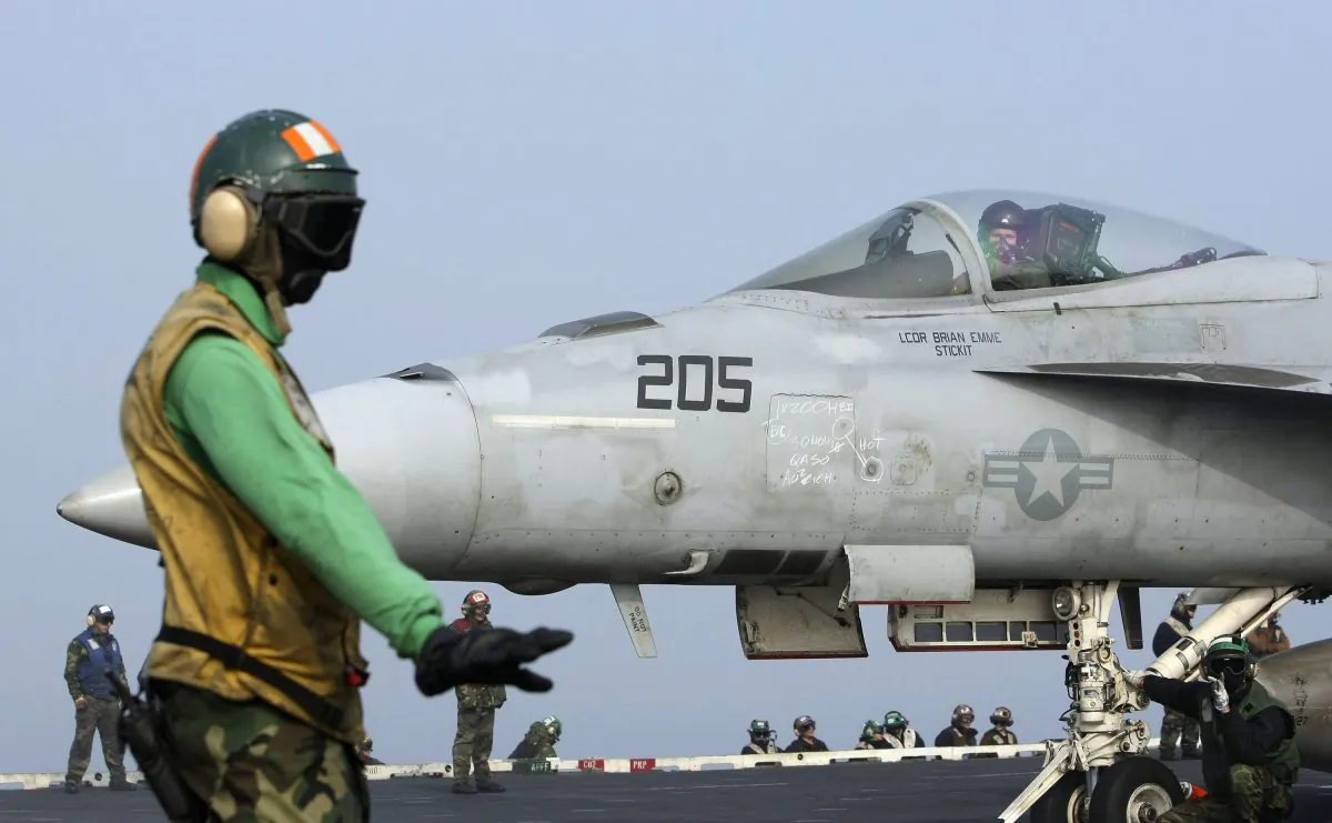 A U.S. Navy F/A-18E Super Hornet fighter attack aircraft taxies on the deck of the USS George Washington during a joint military exercise off South Korea's West Sea on Nov. 30, 2010. (AP Photo/Wally Santana) 