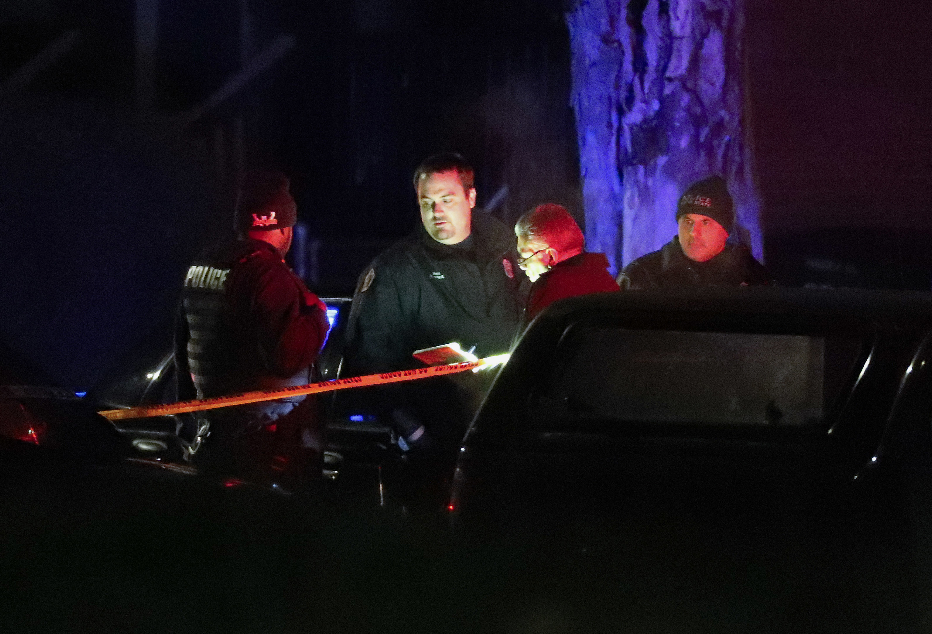 Police search the area where an officer who works for Wayne State University was shot in the head while on duty near the campus in Detroit on Nov. 22, 2016. (AP Photo/Paul Sancya)