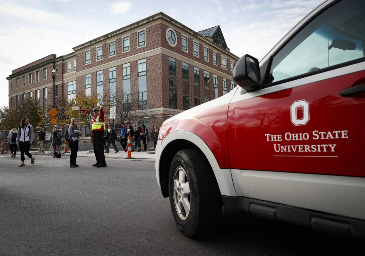 Students leave buildings as police respond to an attack on campus at Ohio State University, in Columbus, OH., on Nov. 28, 2016. (AP Photo/John Minchillo)