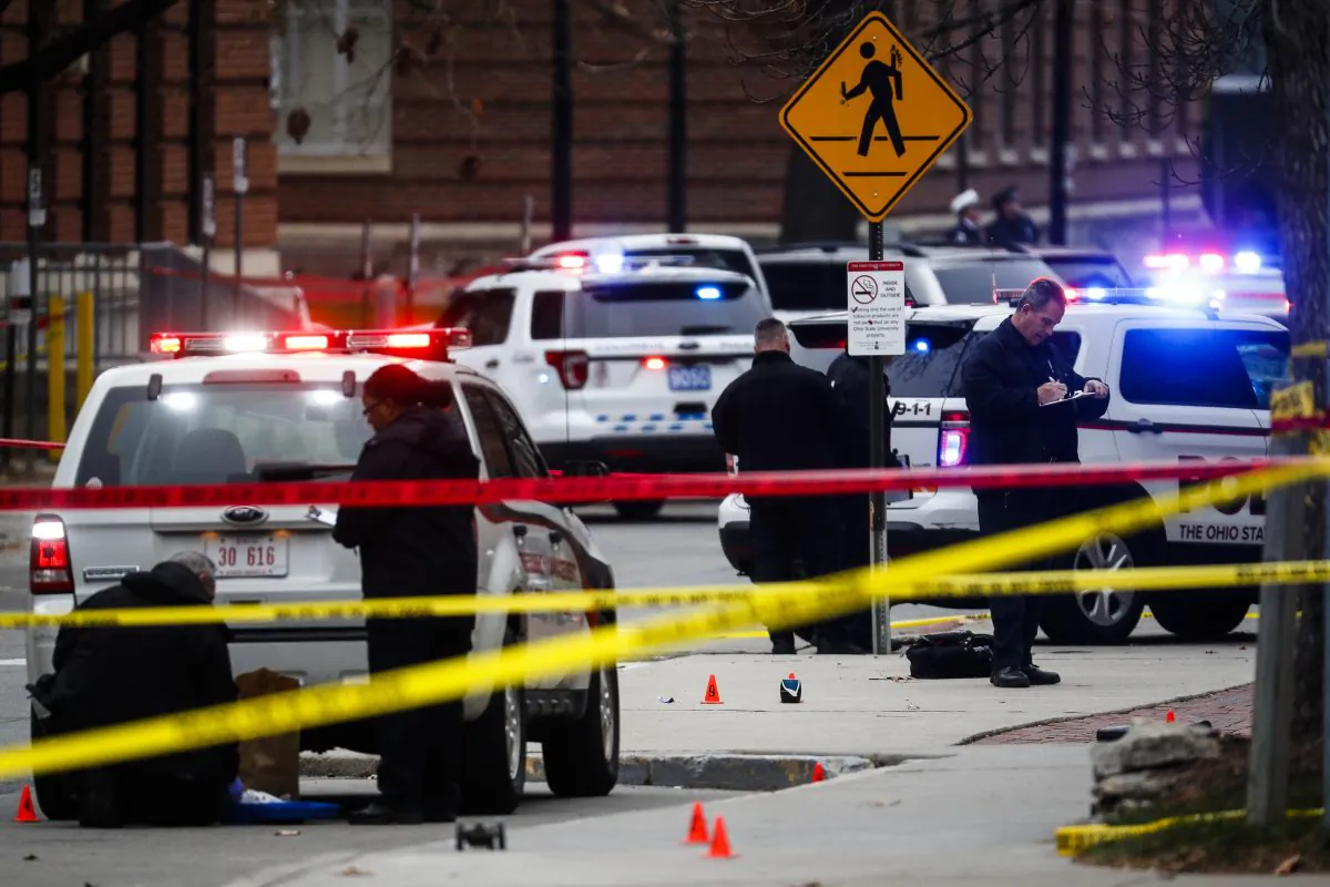 Crime scene investigators collect evidence from the pavement as police respond to an attack on campus at Ohio State University, in Columbus, OH., on Nov. 28, 2016. (AP Photo/John Minchillo)