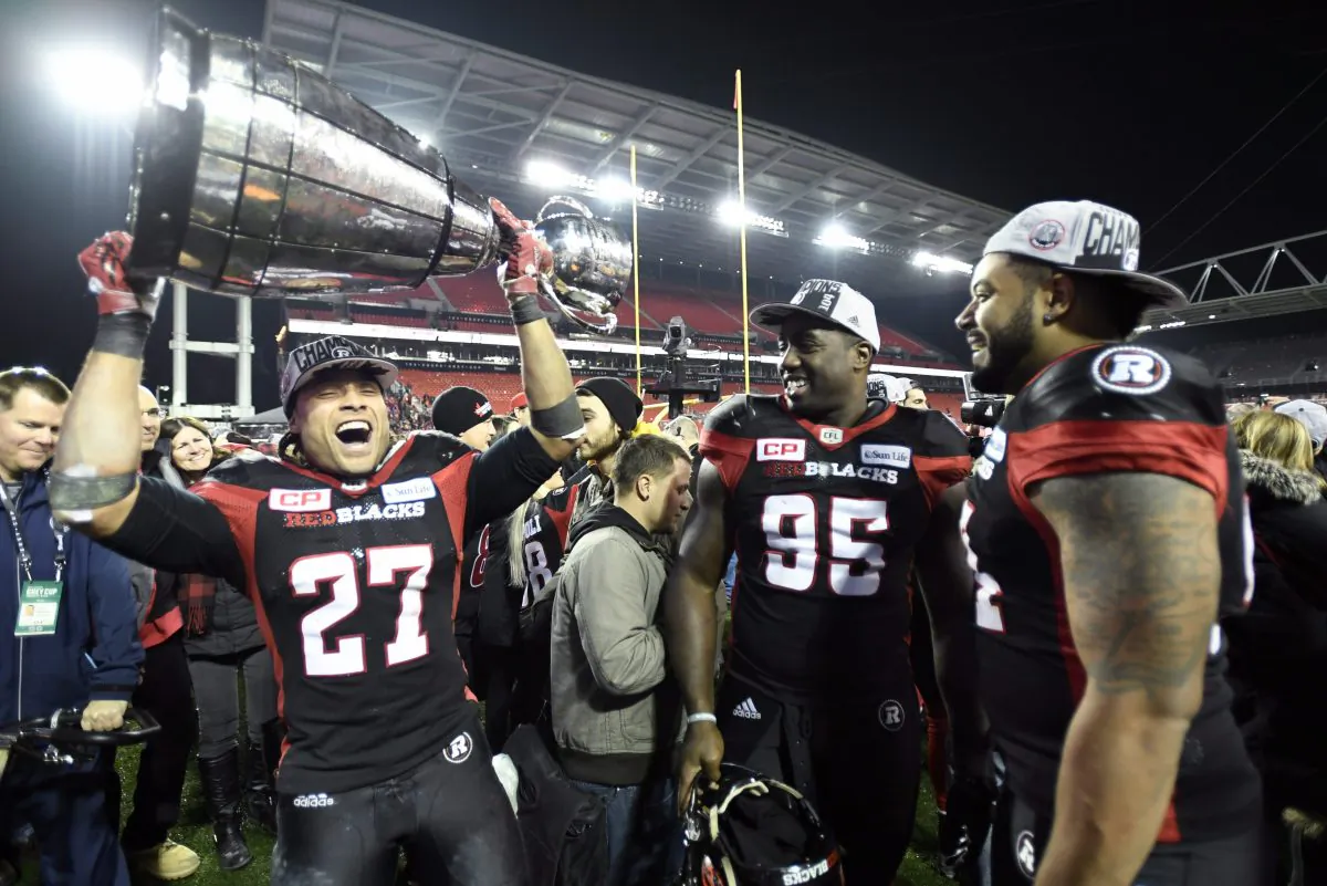 Kienan Lafrance (27) holds up the Grey Cup after the Ottawa Redblacks stunned the Calgary Stampeders in Toronto on Nov. 27, 2016. (The Canadian Press/Frank Gunn)