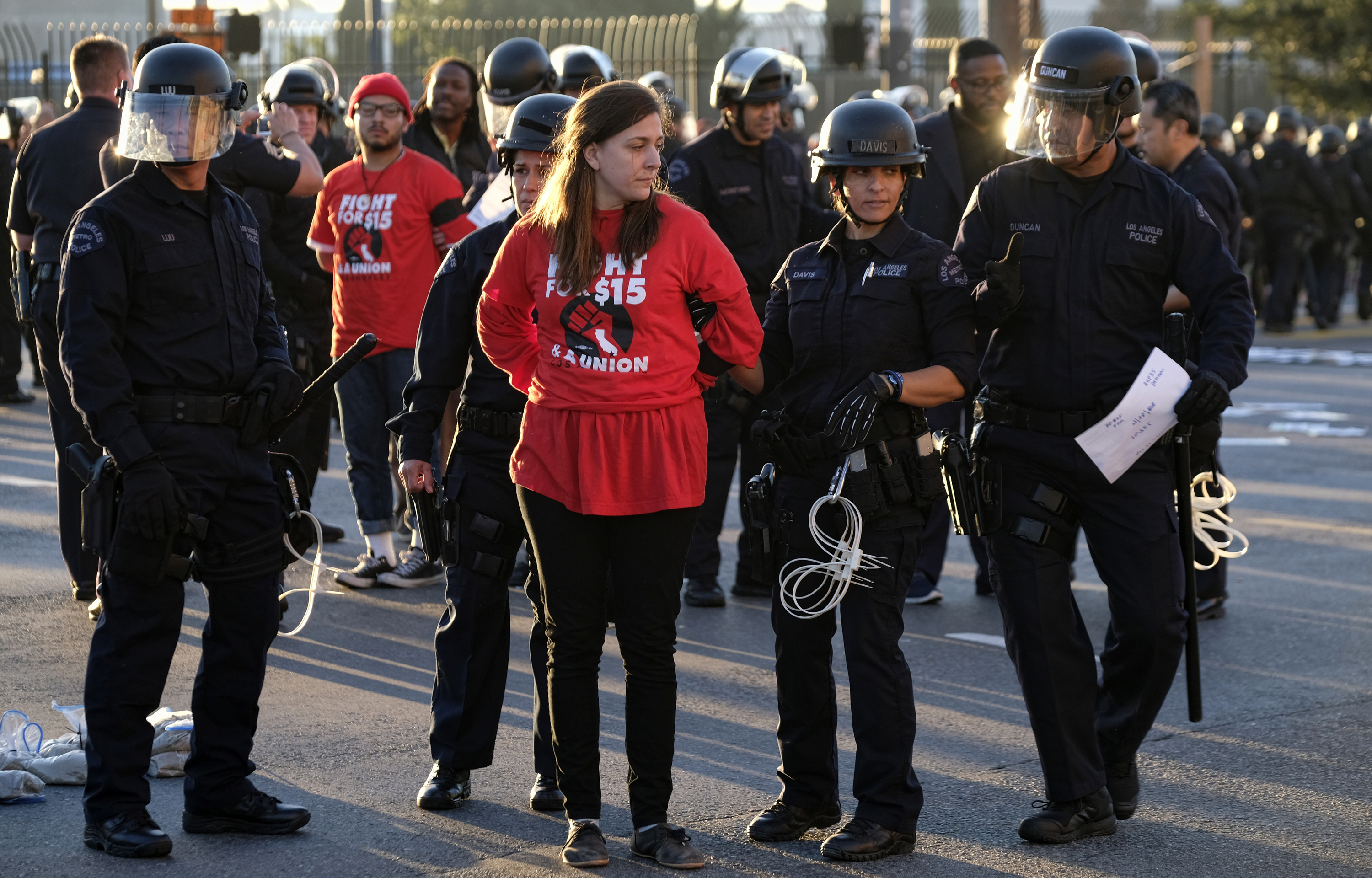 Protesters are arrested and taken into custody during a wage protest in dow...