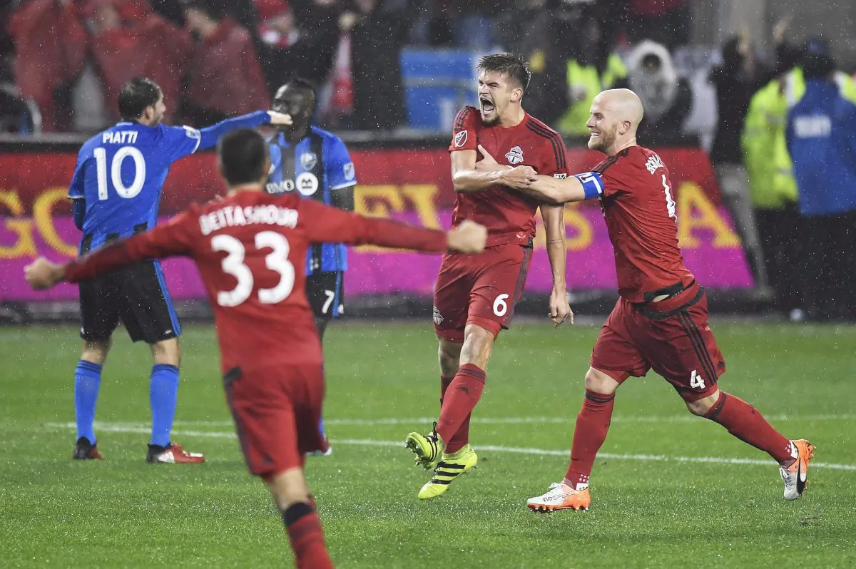 Toronto FC defender Nick Hagglund (6) celebrates his goal against the Montreal Impact with teammates Michael Bradley (4) and Steven Beitashour (33) in Toronto on Nov. 30, 2016. (The Canadian Press/Frank Gunn)