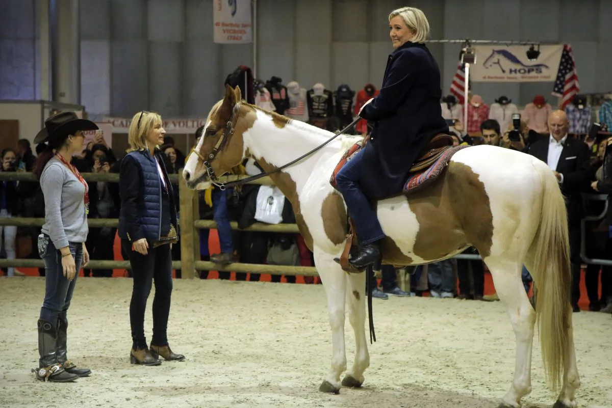 Far-right leader and candidate for next spring presidential elections Marine le Pen rides a horse as she visits the annual Horse Fair in Villepinte, outside Paris, on Dec. 2, 2016. (AP Photo/Michel Euler)