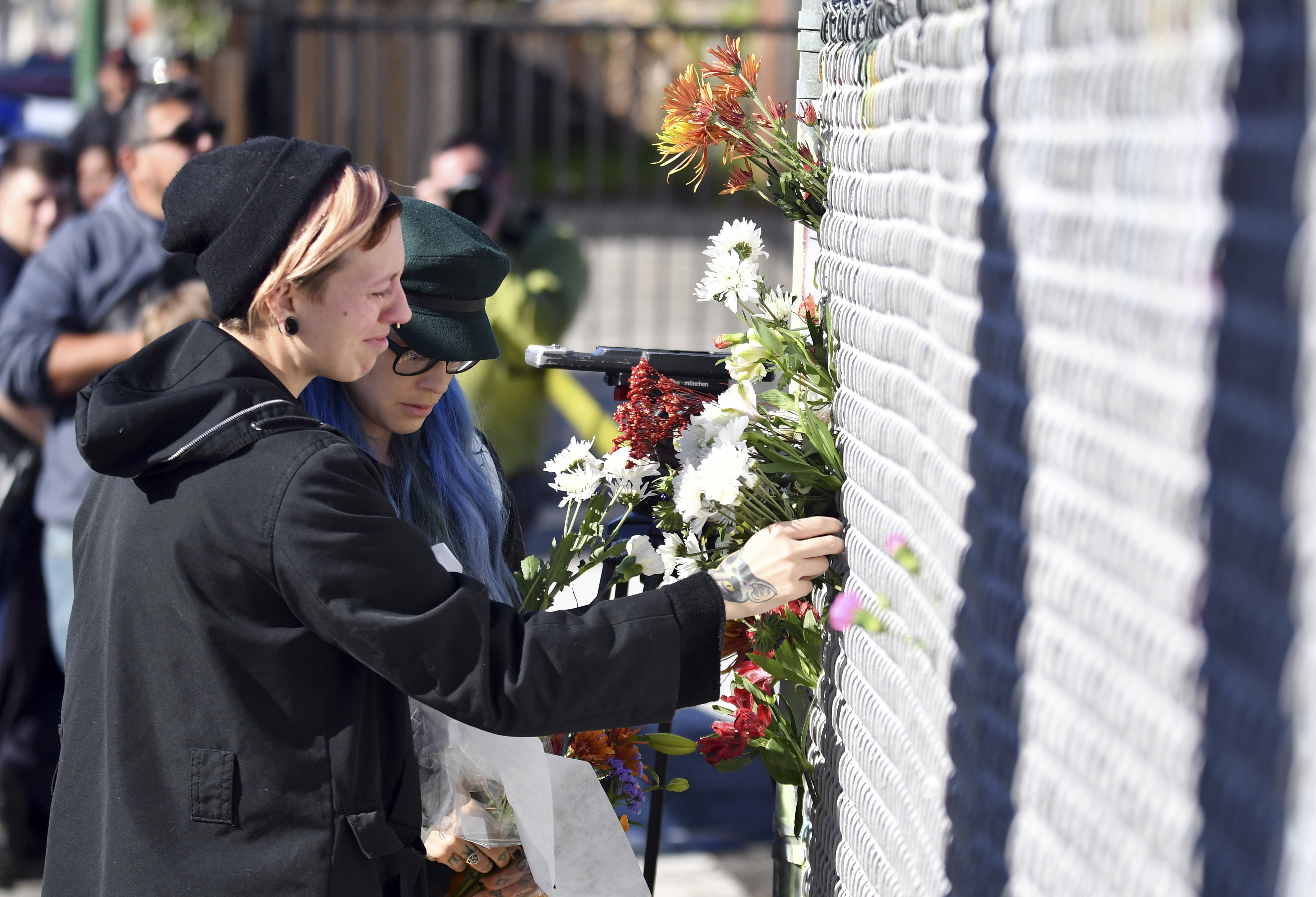 People place flowers near the scene of a warehouse fire in Oakland, Calif., on Dec. 3, 2016. (AP Photo/Josh Edelson)