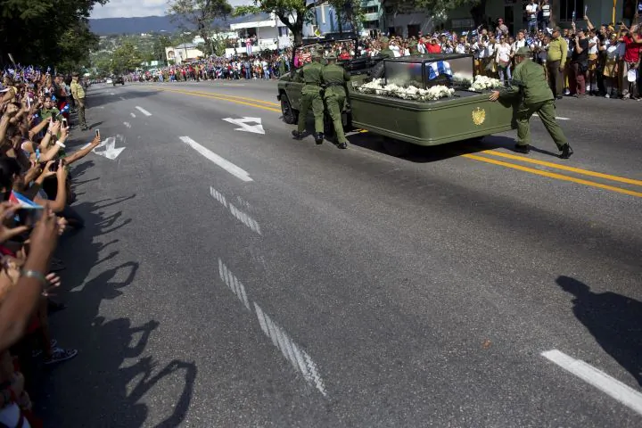 Soldiers push the jeep and trailer carrying the ashes of the late Fidel Castro after the jeep briefly stopped working during Castro's funeral procession near Moncada Fort in Santiago, Cuba, Saturday, Dec. 3, 2016. Castro's ashes will be interred Sunday in Santiago, ending a nine-day period of mourning that saw Cuba fall silent as thousands paid tribute to photographs of Castro and sign oaths of loyalty to his socialist, single-party system. (AP Photo/Rodrigo Abd)