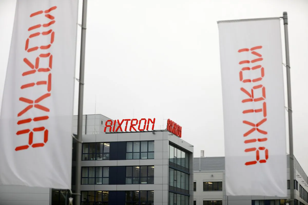 Flags fly outside headquarters of chip equipment maker Aixtron in Herzogenrath, Germany on Oct. 25. Acquisition of Aixtron was blocked by President Obama last week.
(Oliver Berg/AFP/Getty Images)