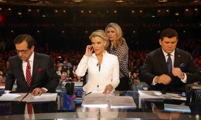 Moderators Bret Baier, Megyn Kelly and Chris Wallace take the stage before a Republican presidential primary debate at Fox Theatre on March 3, 2016, in Detroit. (AP Photo/Paul Sancya)