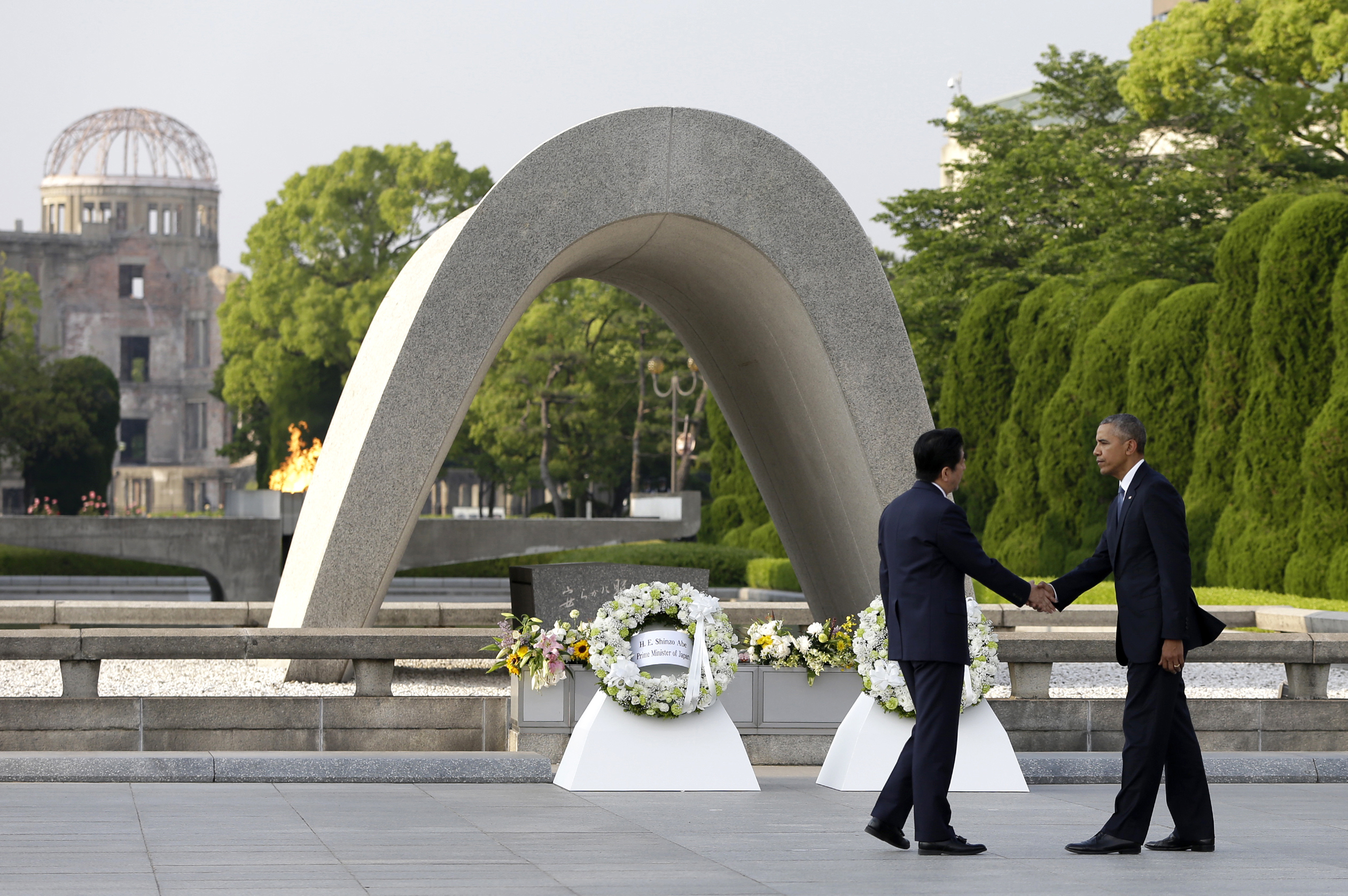 U.S. President Barack Obama (R) shakes hands with Japanese Prime Minister Shinzo Abe at Hiroshima Peace Memorial Park in Hiroshima, western Japan, as Obama became the first sitting U.S. president to visit the site of the world's first atomic bomb attack on May 27, 2016. (AP Photo/Carolyn Kaster, File)