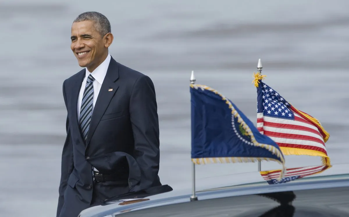 President Obama walks across the tarmac to greet a crowd of well-wishers after arriving at Tampa International Airport aboard Air Force One in Tampa, Fla., on Dec. 6, 2016. (AP Photo/Steve Nesius)