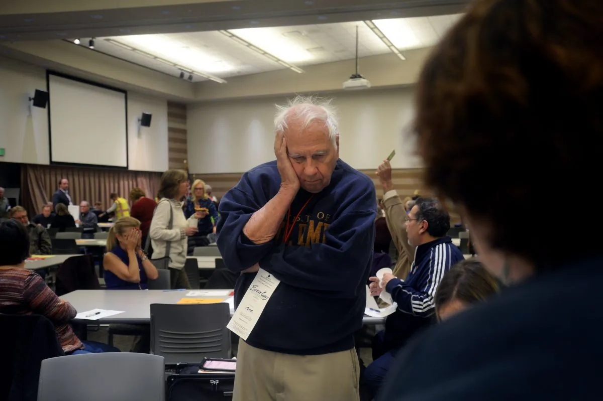 Burke Cueny, of Rochester, watches as volunteers and city officials participate in a recount after a federal judge ordered the statewide recount at the Oakland Schools Conference Center in Waterford Township, Michigan on Dec. 5, 2016. (Rachel Woolf/Getty Images)