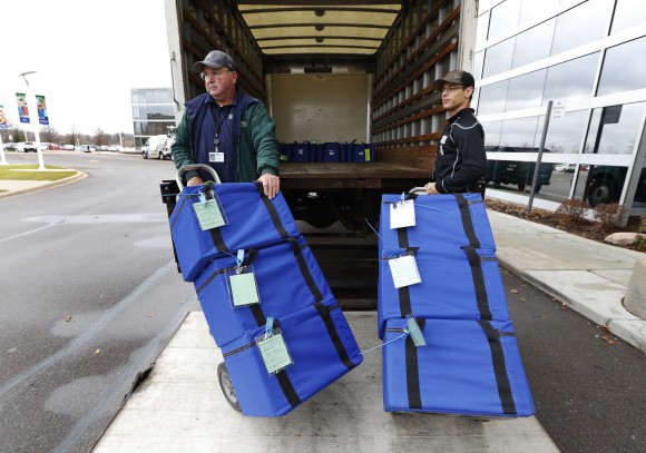 Ballots are unloaded during a statewide presidential election recount in Waterford Township, Mich. on Dec. 5, 2016. A judge ordered a hand recount of Michigan's presidential results. (AP Photo/Paul Sancya)
