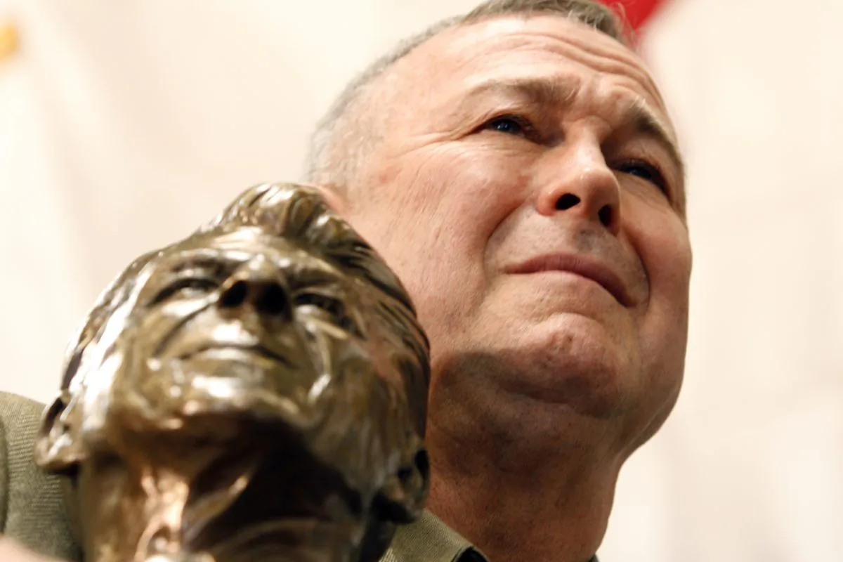 Rep. Dana Rohrabacher, R- Calif., holds a bust of Ronald Reagan as he listens to Republican presidential hopeful former Massachusetts Gov. Mitt Romney campaign at Bassett Furniture in Fountain Valley, Calif., Thursday, Jan. 31, 2008. (AP Photo/LM Otero )