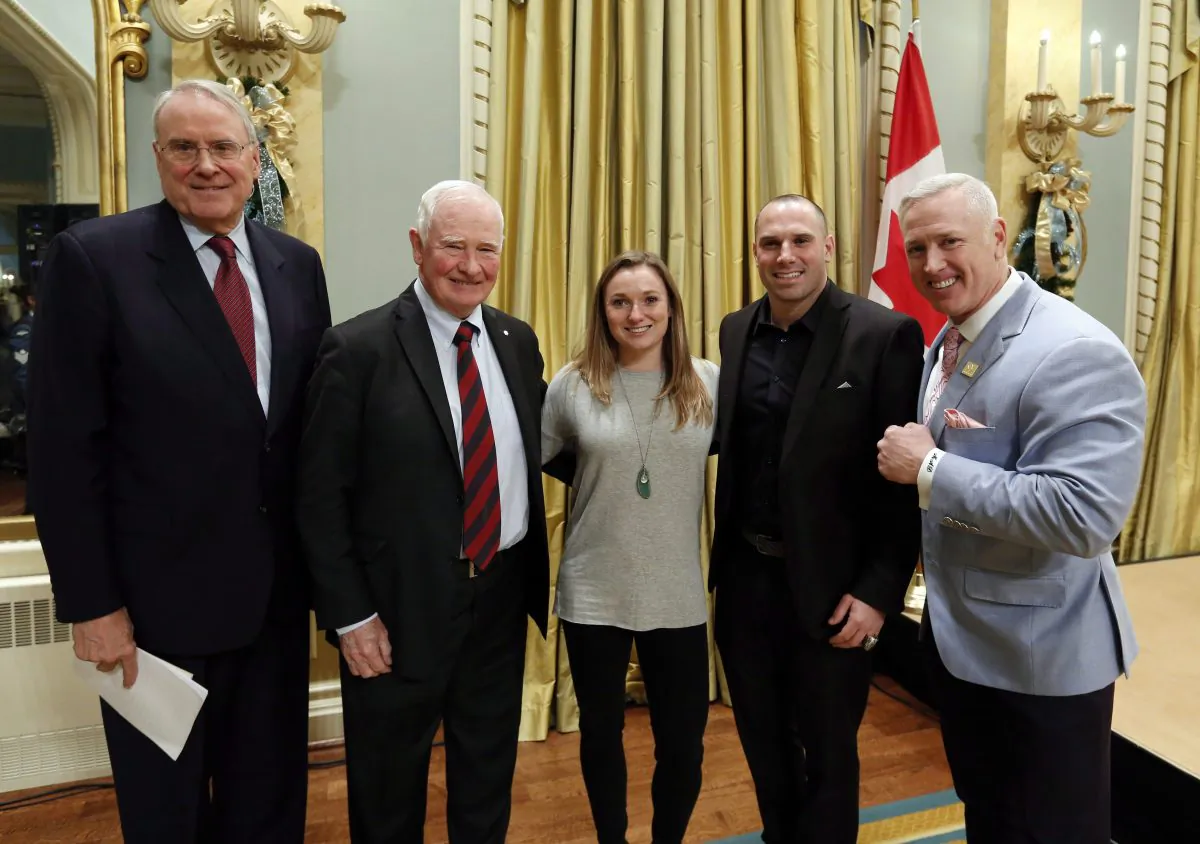 Ken Dryden, retired NHL goaltender, Governor General David Jonhston, Olympic trampolinist Rosie MacLennan, and retired CFL players Etienne Boulay and Matt Dunigan (L to R) take part in "We Can Do Better" at the Governor General's Conference on Concussions in Sport at Rideau Hall in Ottawa on Dec. 6. (The Canadian Press/Fred Chartrand)